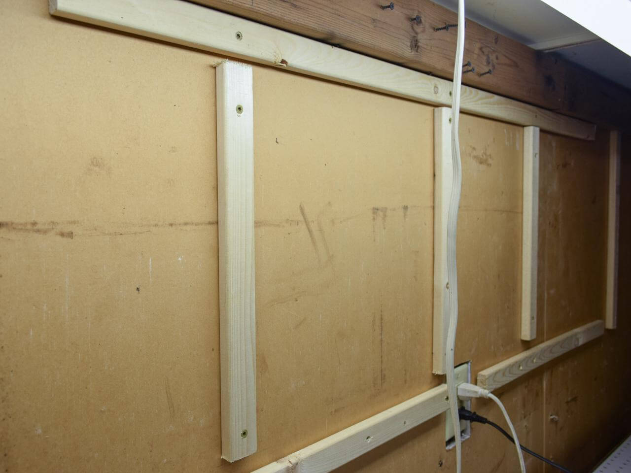HOW TO BUILD WALL MOUNTED GARAGE SHELVES. 4. INSTALL THE SUPPORTING BOARDS